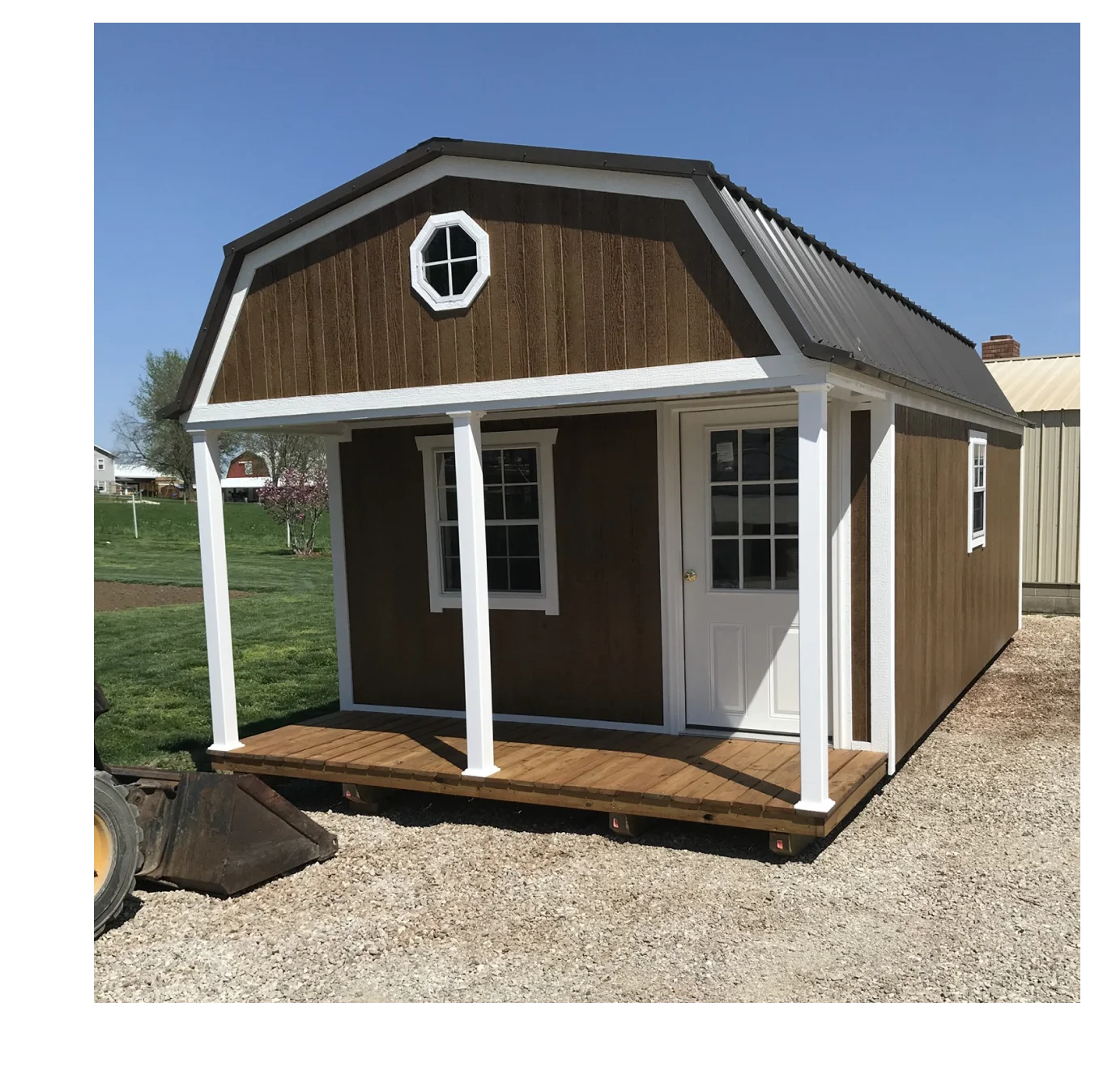 Brown barn-style shed with porch.